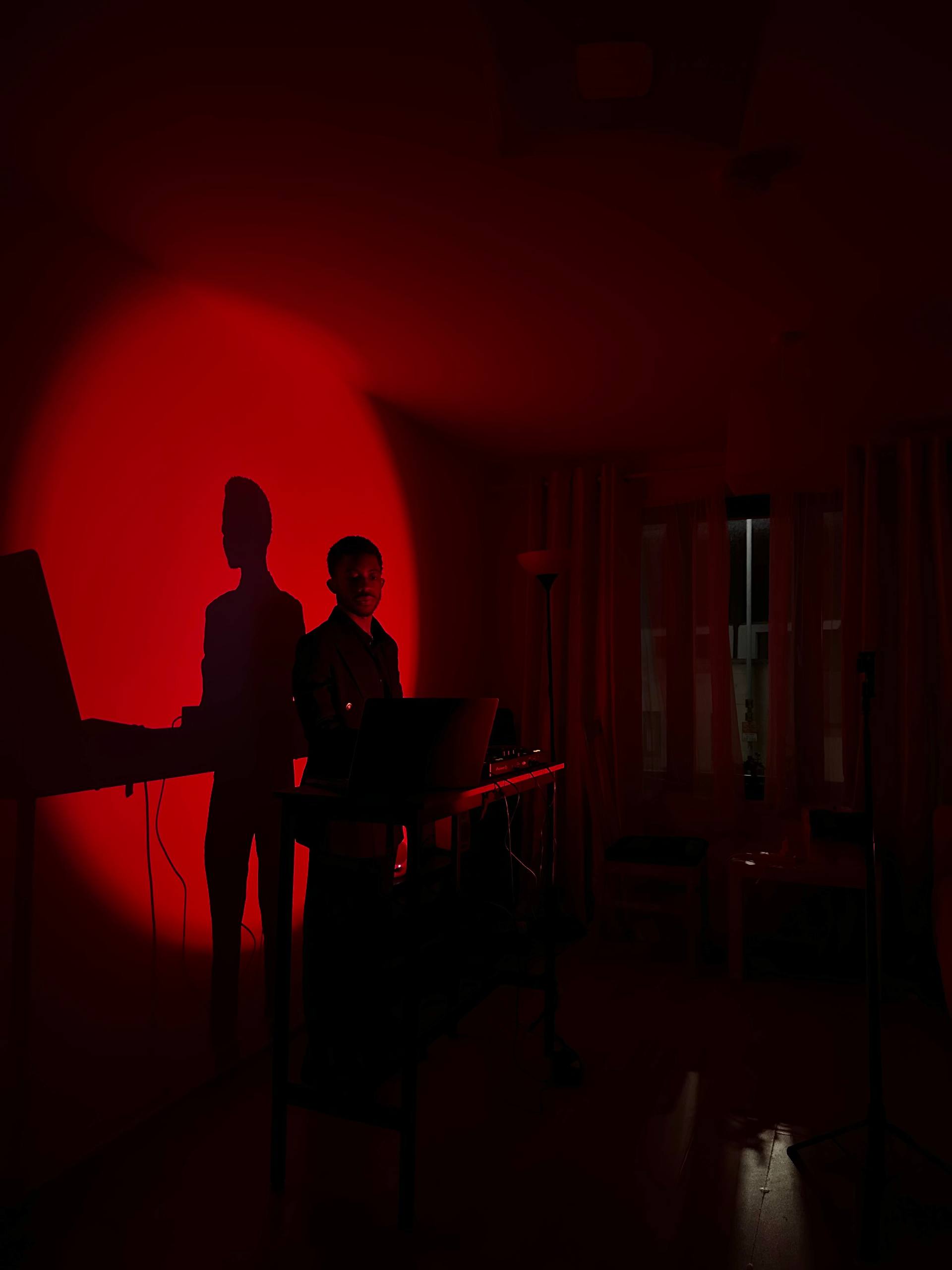 varyence performing a DJ set under red light